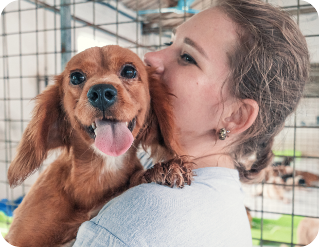 A woman holding a dog.